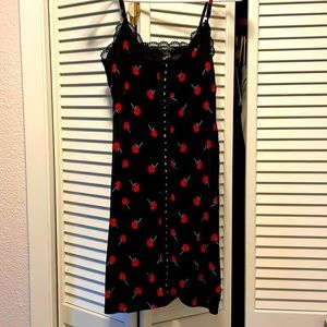Black body hugging dress with red roses